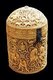 This cylindrical pyxis - a kind of casket - was carved in 968 for Prince al-Mughira (son of the deceased Caliph Abd al-Rahman III and half-brother of the reigning Caliph al-Hakam). It is the finest example of the luxury ivory objects made for the members of the court of Madinat al-Zahra (the caliph's residence and city of government, established near Cordoba in 936).<br/><br/>

Its four richly-decorated medallions are linked by borders of delicately pierced foliage, and this composition is reflected on the lid, whose medallions feature peacocks, falcons, lions, and a rider. There are four scenes on the body of the box. In one of these, a lutanist is flanked by two cross-legged figures who look at each other rather suspiciously.<br/><br/>

One holds a fan, the other a bottle (an emblem often associated with the king), and a braided vegetal scepter of the kind used by the Umayyad Dynasty. The other images, such as that of a bull attacked by a lion, are all doubled. Some curious little scenes show back-to-back figures stealing eggs from falcons' nests, with dogs biting their ankles, and the final medallion portrays riders picking bunches of dates.
